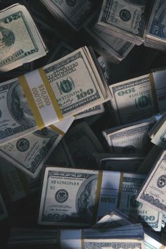 black and white photograph of stacks of one hundred dollar bills with the image taken from above