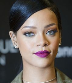 a close up of a woman with purple lipstick