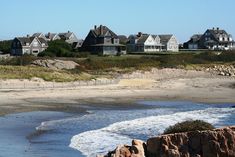 houses on the beach with waves coming in to shore