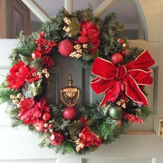 a christmas wreath is hanging on the front door