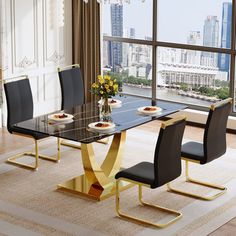 a dining room table with black chairs and a chandelier