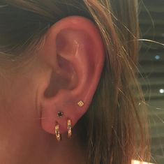 a close up of a person's ear wearing earrings