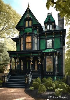 an old victorian style house with green trimmings and black paint on the front