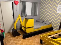 a bedroom with yellow construction themed furniture in it