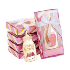 two pink boxes with bottles in them and a white ribbon around the top that says poppin bottles