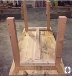 a chair made out of wood sitting on top of a floor