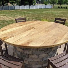 an outdoor table with four chairs around it