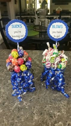 two vases filled with candy sitting on top of a counter