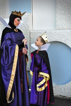 two people dressed in costumes standing next to each other