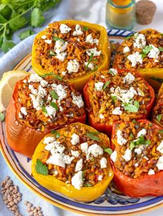 stuffed bell peppers with feta cheese and herbs on a plate next to some mustard