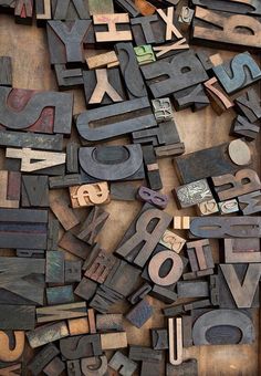 an old wooden box filled with lots of different type of letters