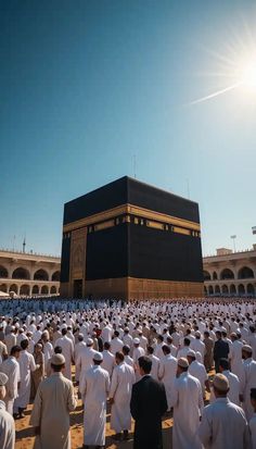 a large group of men standing in front of the ka'bah, which is surrounded by black stone walls