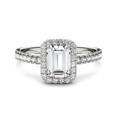 an emerald - cut diamond ring with pave set shoulders and halos around the band