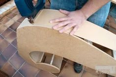 a man is sanding down a piece of furniture