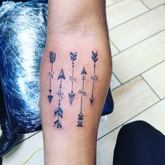 a person with a tattoo on their leg that has an arrow and arrows all over it