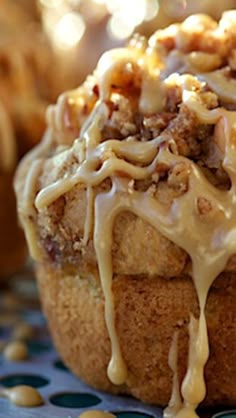 a muffin with icing and nuts sitting on a table