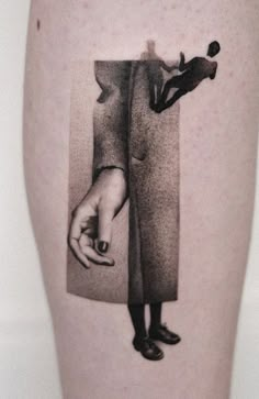 a black and white photo of a person's leg with the image of a man holding a woman's hand