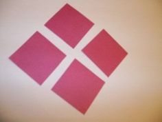 a close up of a red square logo on a white surface