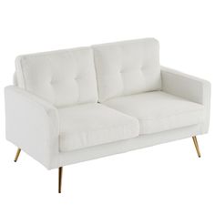 a white couch sitting on top of a wooden table