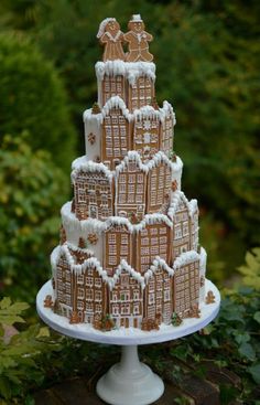 a three tiered gingerbread christmas cake on a pedestal