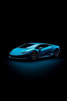 a blue sports car in the dark