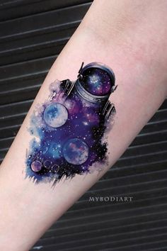 an arm with a space themed tattoo on it