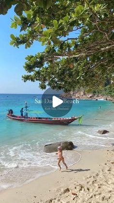 a person running on the beach with a boat in the water and people walking around