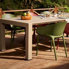 an outdoor table and chairs on a deck