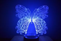 a blue light that is shaped like a butterfly with wings spread out, sitting on a table