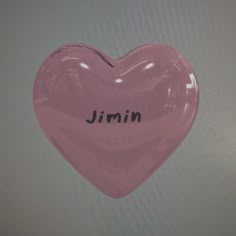 a pink heart shaped object with the word jimmy written on it's side in black ink