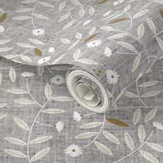 a grey and white wallpaper with gold leaf designs on the fabric, it is very soft