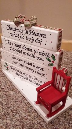 a red chair sitting on top of a pile of white boxes with writing on it