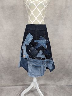 a mannequin wearing a skirt made out of old denims and other items