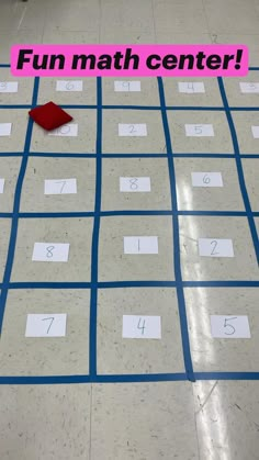 a red piece of paper sitting on top of a floor next to a number line