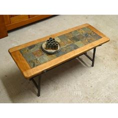 a coffee table with a tile top and metal legs