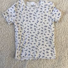 This Shirt Is Super Cute And Never Worn No Flaws Barely Cropped Smoke Free Home This Shirt Is Perfect For Springtime And Summer To Style With Leggings Or Jeans! Cute Patterned Cotton Tops, Cute Cotton Tops With Pattern, Cute Cotton Patterned Tops, Patterned Short Sleeve Cotton Tops, Patterned Cotton Short Sleeve Tops, Patterned Cotton Crew Neck Top, Casual White Tops With Floral Print, Casual Cotton Patterned Tops, Cute Printed Blue Tops