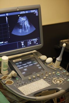 an x - ray machine sitting on top of a table next to a computer monitor