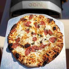 a pizza sitting on top of a wooden cutting board