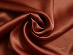 a close up view of a red satin fabric