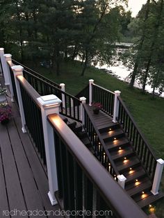 an outdoor deck with lights on the railing