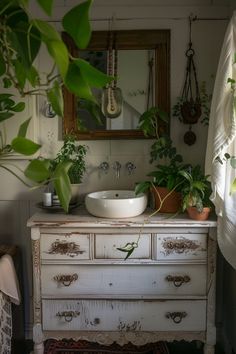 a bathroom with a sink, mirror and potted plants