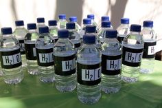 several bottled water bottles are lined up on a table with labels that read h2h