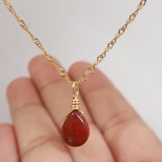 Introducing our stunning, handcrafted Red Jasper necklace with Pyrite accents, set in 18K Gold Filled chain. This exquisite piece of jewelry showcases the natural beauty and vibrant hues of Red Jasper, complemented by the sparkling Pyrite. Its unique and eye-catching design makes it the perfect accessory for any outfit, adding a touch of elegance and sophistication. Red Jasper is known for its grounding and stabilizing properties, while Pyrite is believed to promote prosperity and success. Toget Red Jasper Pendant, Affordable Red Spiritual Necklace, Gold Wire-wrapped Drop Necklace As Gift, Gold Wire Wrapped Drop Necklace As Gift, Gold Wire-wrapped Drop Necklace For Gift, Gold Wire Wrapped Drop Necklace For Gift, Red Carnelian Teardrop Necklaces, Red Wire Wrapped Pendant Necklace, Red Carnelian Teardrop Necklace