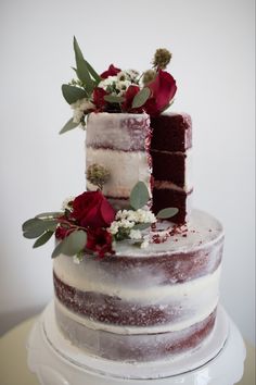 a three layer cake with flowers on top