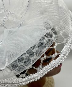 READY FOR SHIPPING! Round fascinator base with gimp trim and a large round wired brim with vintage birdcage veiling. 2 large double bows made of clear and white crinoline and set at angles of each other and place on top of the headpiece.  White with silver trim band is around the outer edge of the disc and on the top loops of the crinoline bows. The base measures 5" and the wired brim is 11". The headpiece has two gator clamps to secure on the head. All work has been done in a pet and smoke free environment and is ready for next business day shipping. "You won't meet your hat!" White Church Hats, Vintage Birdcage, Vintage Bird Cage, Church Hat, Double Bow, Church Hats, Bird Cage, How To Make Bows, Bridal Wedding