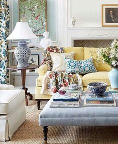 the living room is decorated with blue and white decor, including a yellow couch and coffee table