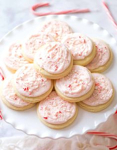 a white plate topped with cookies covered in frosting