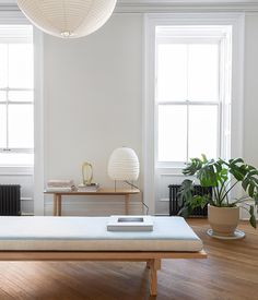 a living room with white walls and wooden floors