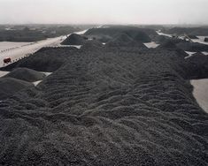 large piles of sand sitting on top of a beach