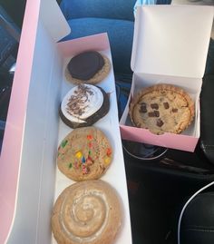 an assortment of cookies and desserts are in the car